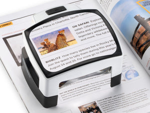 Visolux + on page, magnifying text and an image. Representing handheld and reading magnifiers