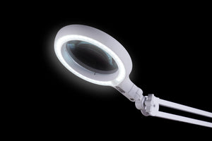 Magnifying lens circled by bright LED lights 