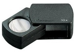 Small circular magnifier encased in black housing and fold-out black case.