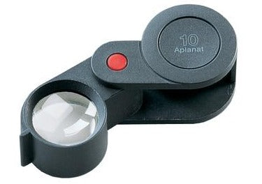 Small circular magnifying lens, encased in black plastic , fold-out case.