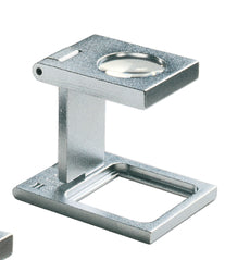 Small circular magnifying lens set in a rectangular metal casing, above a rectangular base.