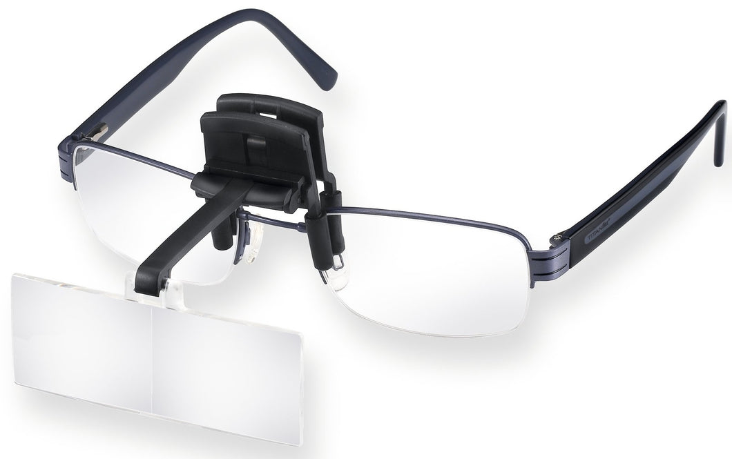 Magnifying lens on black carrier, clipped onto glasses.