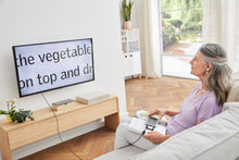 Load image into Gallery viewer, Woman using Smartlux DIGITAL as a screen reader, to read a book on a TV
