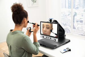 Woman using Vario DIGITAL 16 FHD advanced with mirror function to apply makeup.