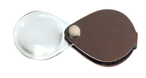 Circular magnifier inside clear oval setting, with attached fold-out brown case