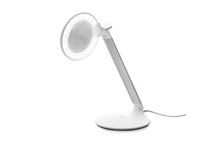 Daylight LED light encircling magnifying lens, with flip-up cover and charging cable. Light housing and base are both circular and white. 