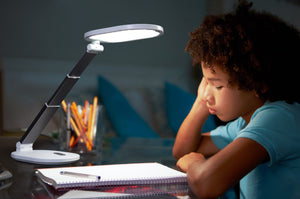 Young boy studying at a desk with Daylight's Foldi Go.