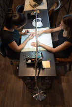 Load image into Gallery viewer, Daylight&#39;s Slimline Floor-standing lamp being used in a nail salon.
